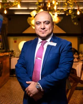 friendly male restaurant manager smiling
