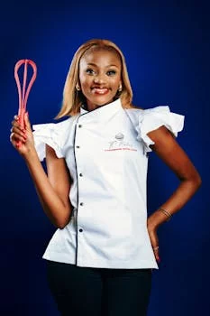 young female chef preparing food in kitchen